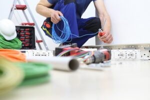 Electrician Kansas City Fusion Electric AdobeStock_271148519 electrician at work with nippers in hand cut the electric cable, install electric circuits, electrical wiring
