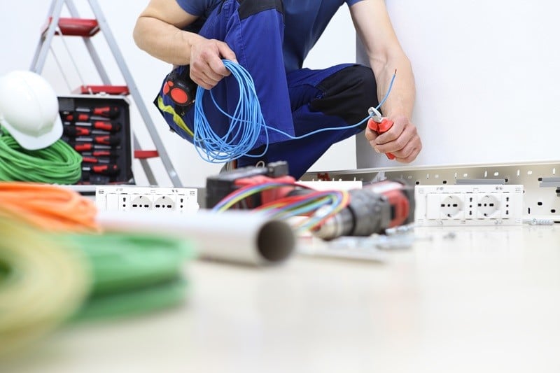 Electrician Kansas City Fusion Electric AdobeStock_271148519 electrician at work with nippers in hand cut the electric cable, install electric circuits, electrical wiring