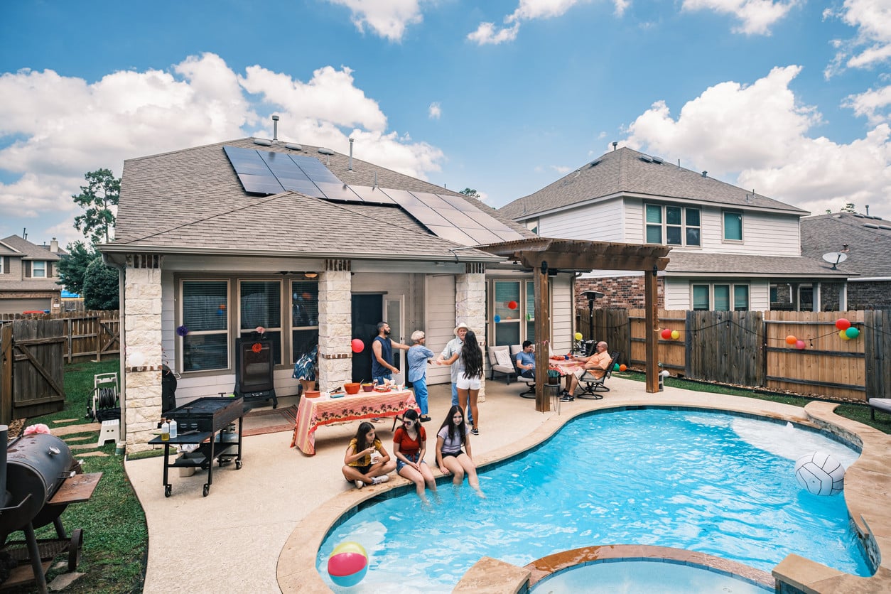 American family enjoying a backyard pool day in Kansas City.